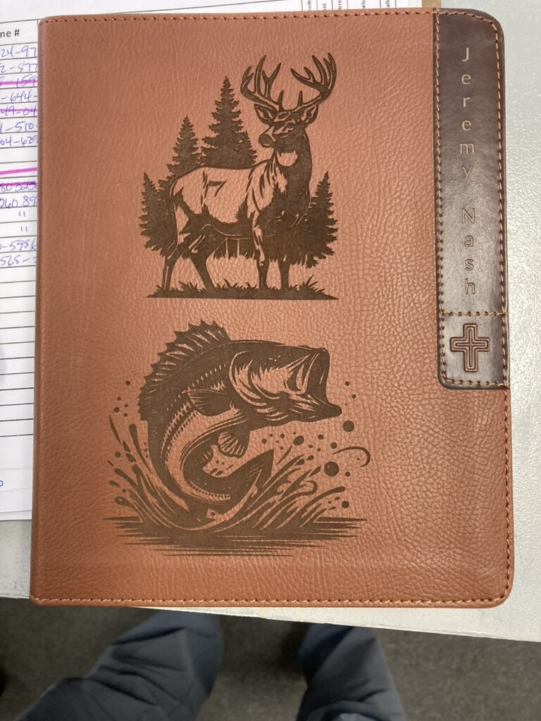 Bible cover laser engraved with an outdoors scene featuring a deer and a fish