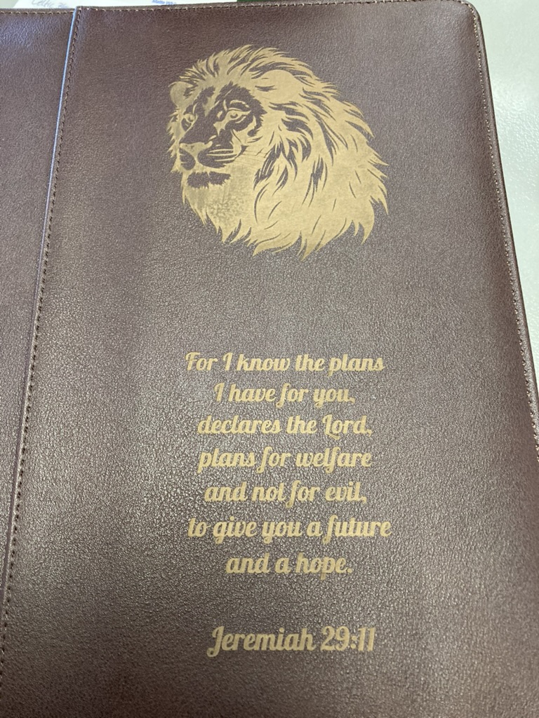 Bible cover laser engraved with a lion and a Scripture verse